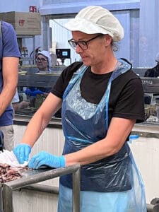 Frau in Fischfabrik